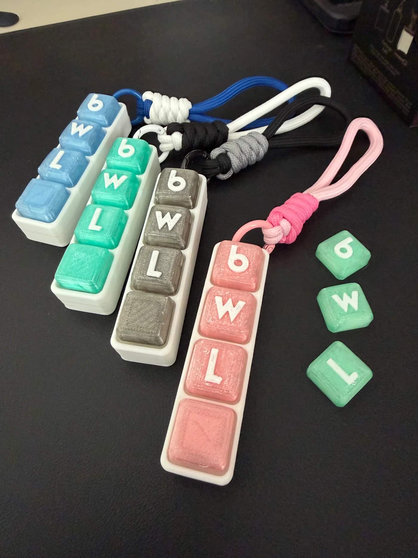 Finished 3D-printed keychains in five colourways, branded for the event